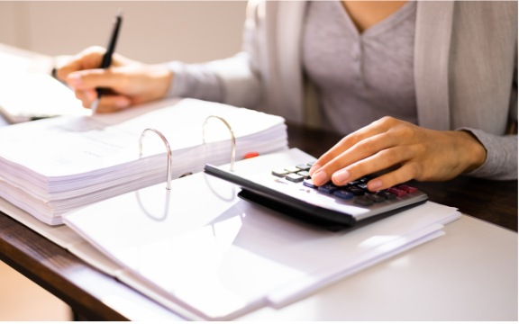 Woman doing taxes, woman working with calculator